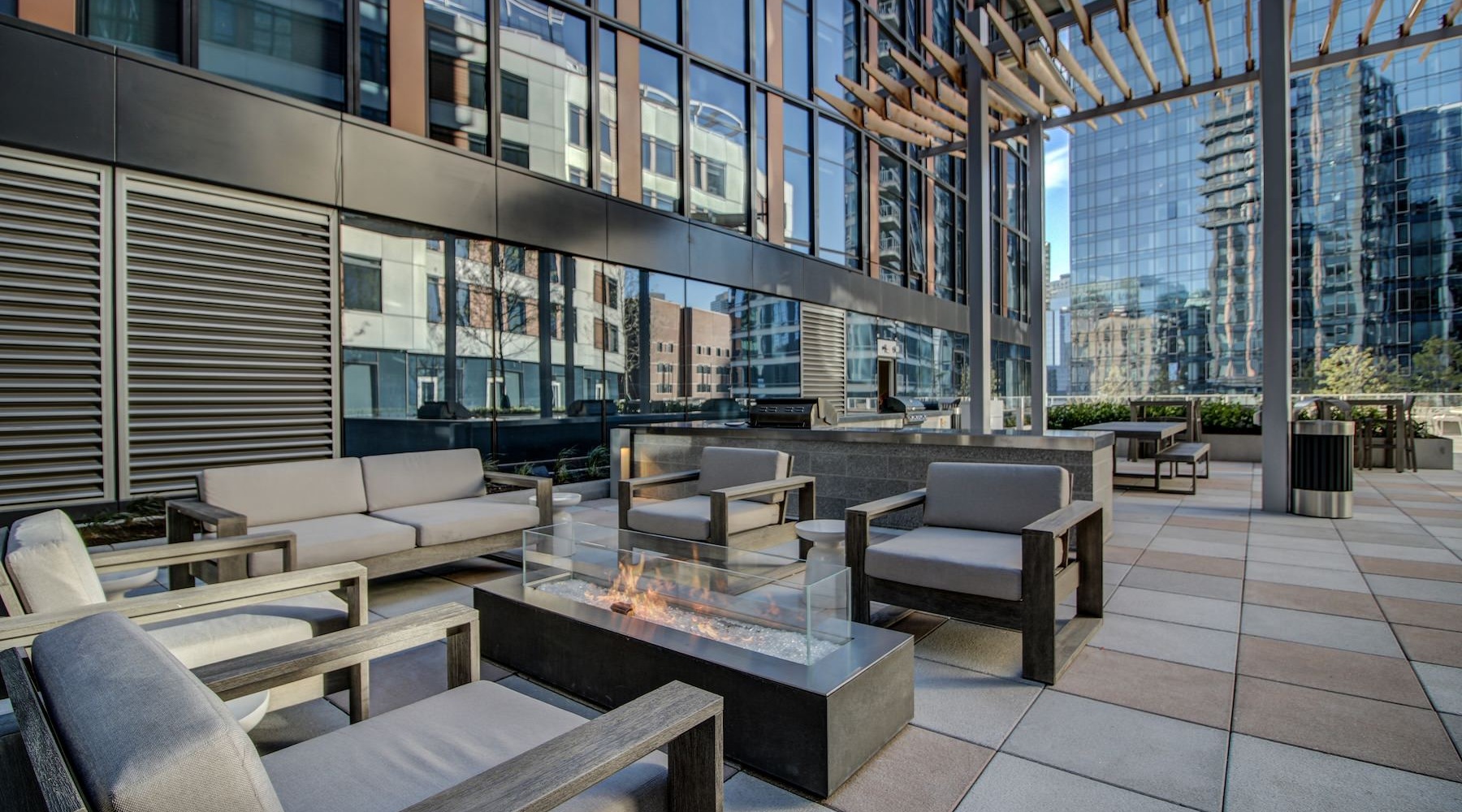 a rooftop lounge with a fire pit