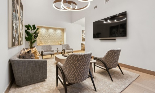 viewing lounge with a tv and chairs