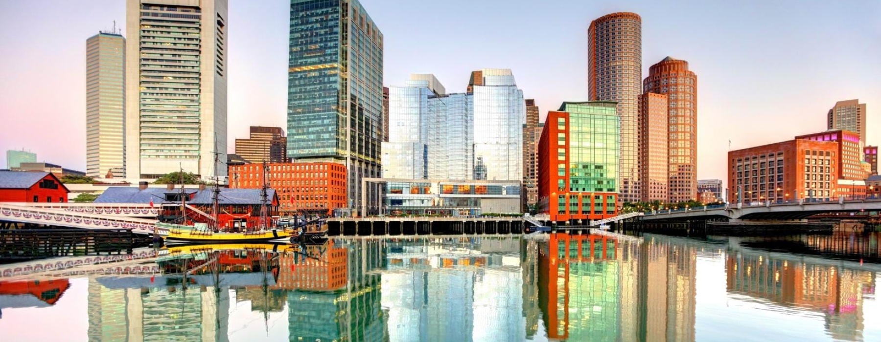 a city skyline with a body of water in front of it